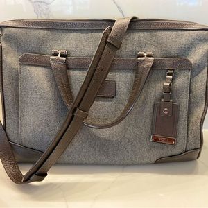 TUMI: laptop bag.